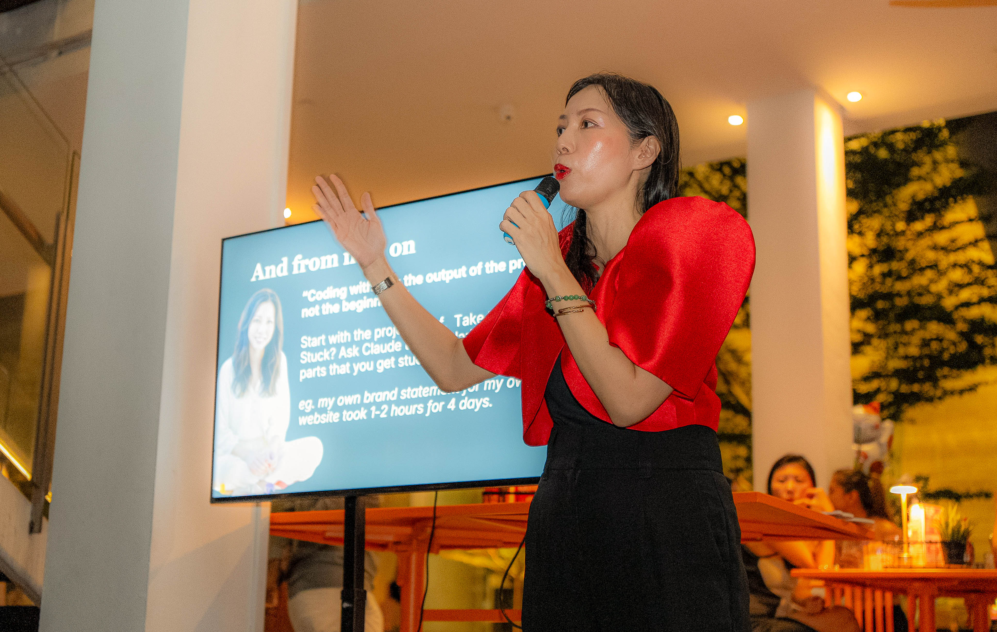 Andrea presenting her first website build beside her slide