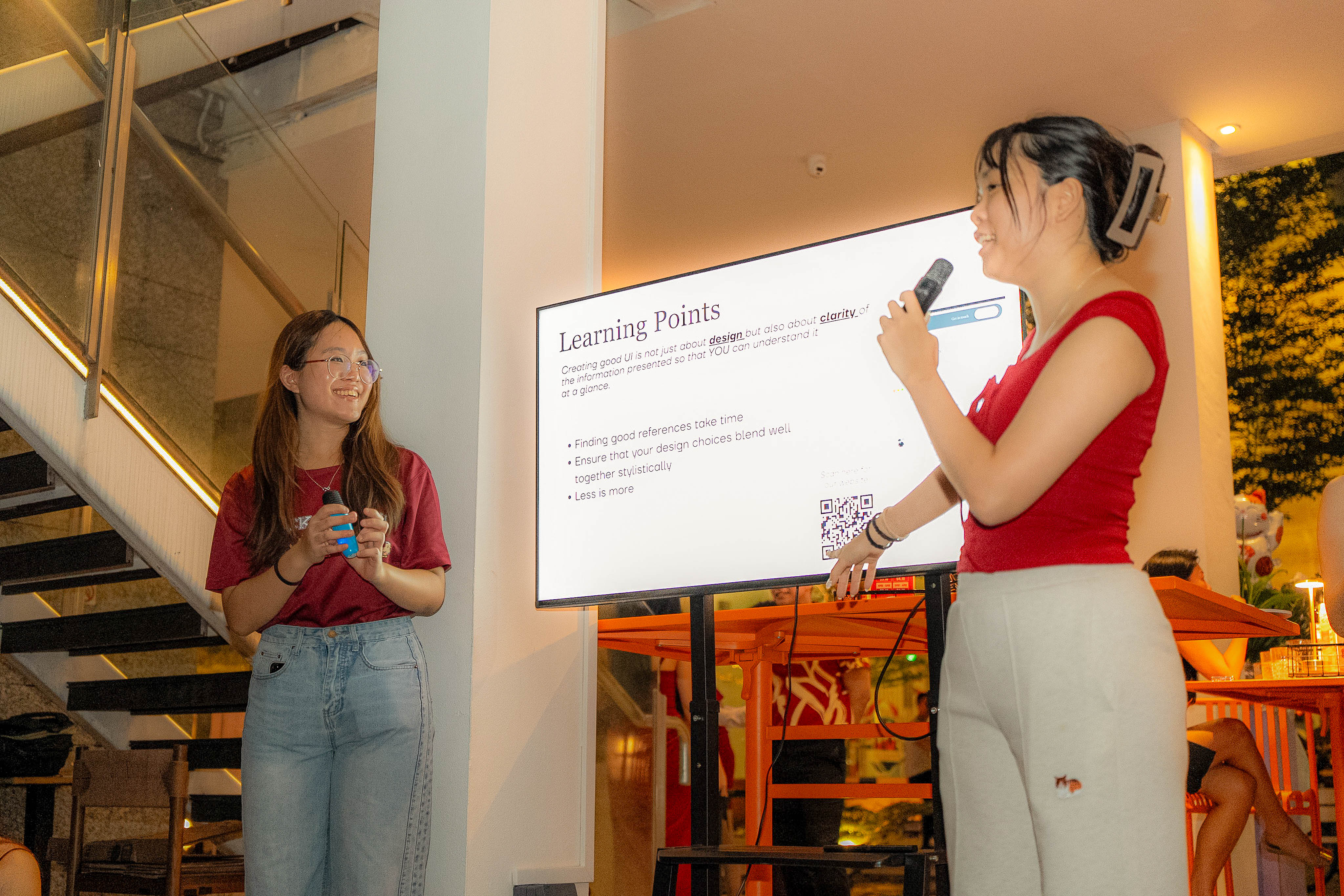 Ashley and Bernise presenting Howdy beside a Learning Points slide