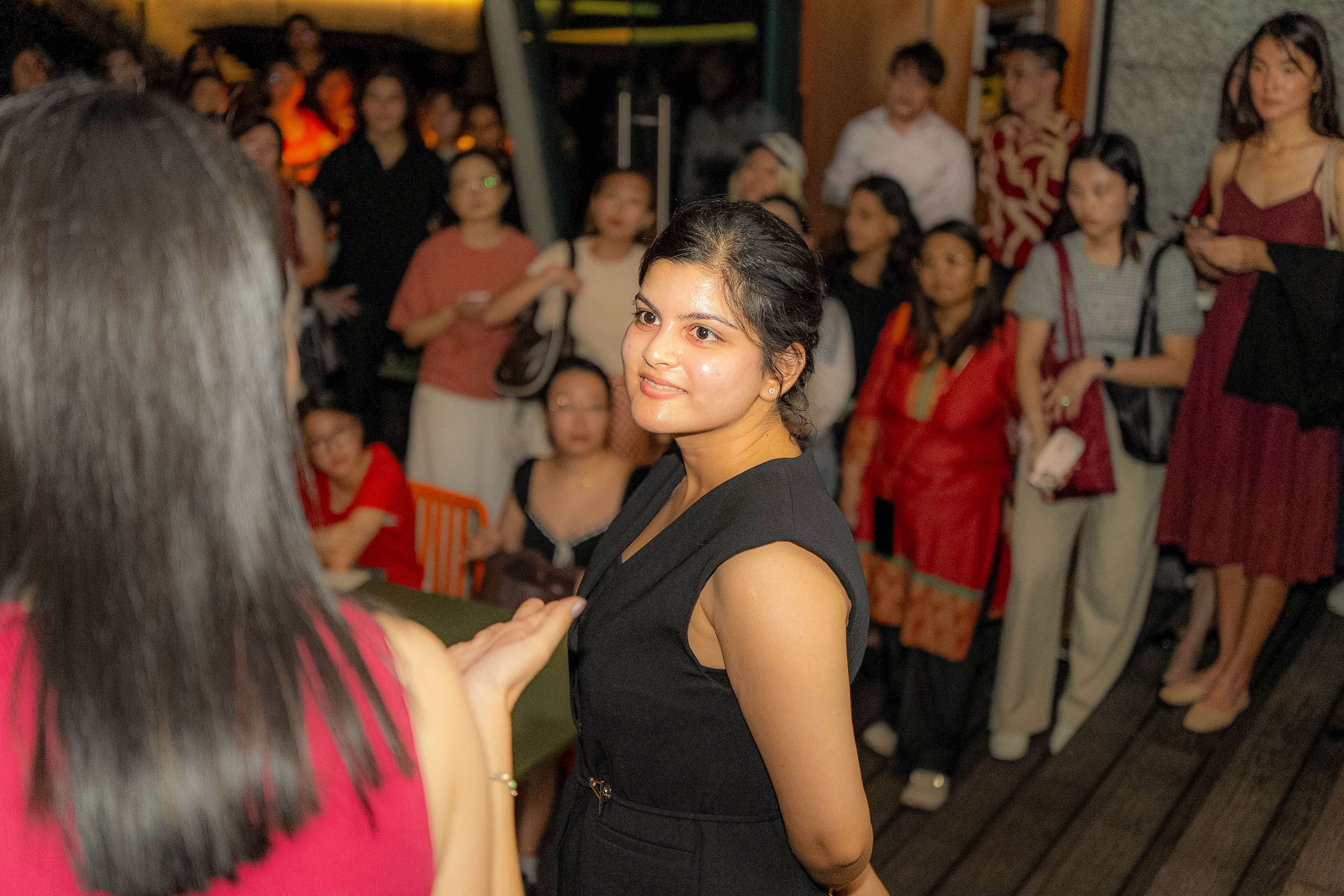 Simran Pant smiling back at the camera in the crowd