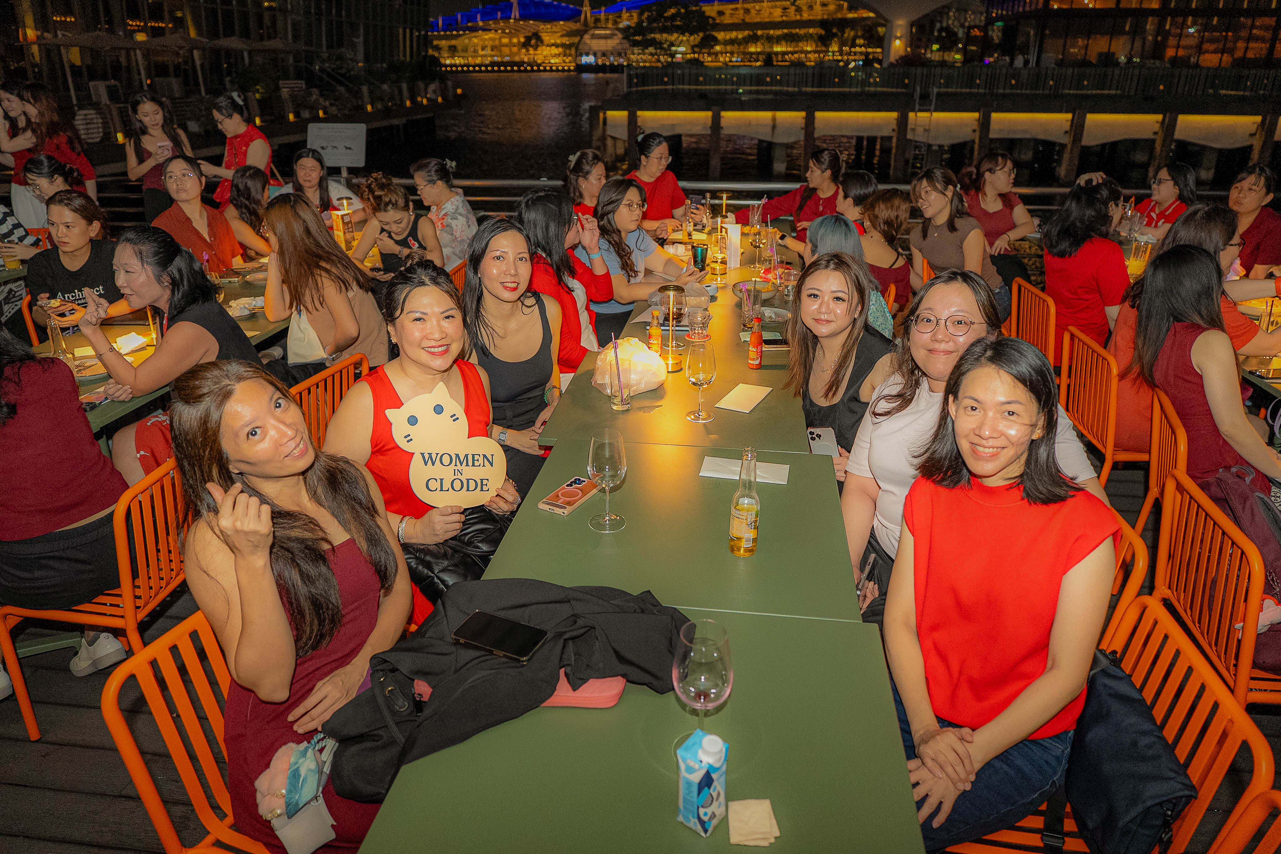 Riverside tables of Clodettes with the Women in Clode sign