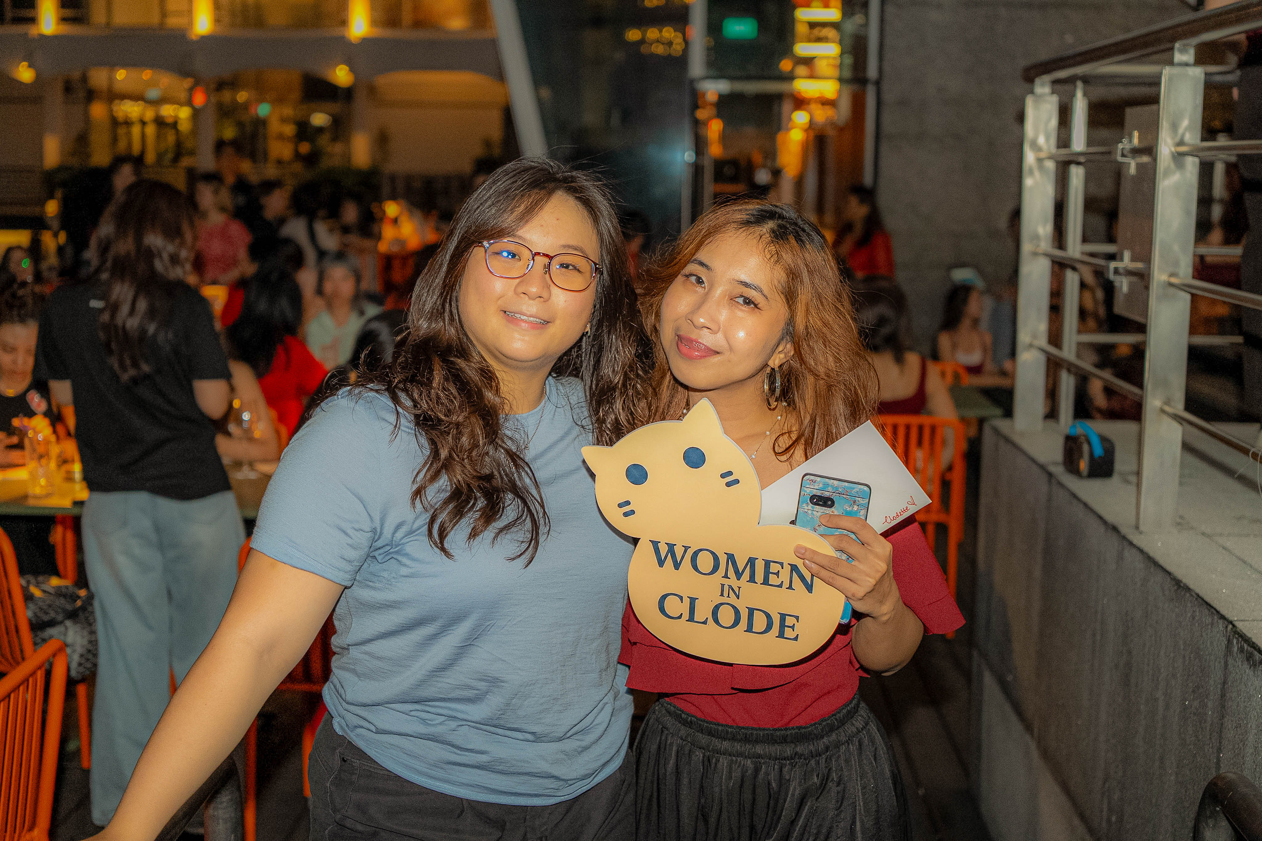 Two Clodettes posing with the Women in Clode sign
