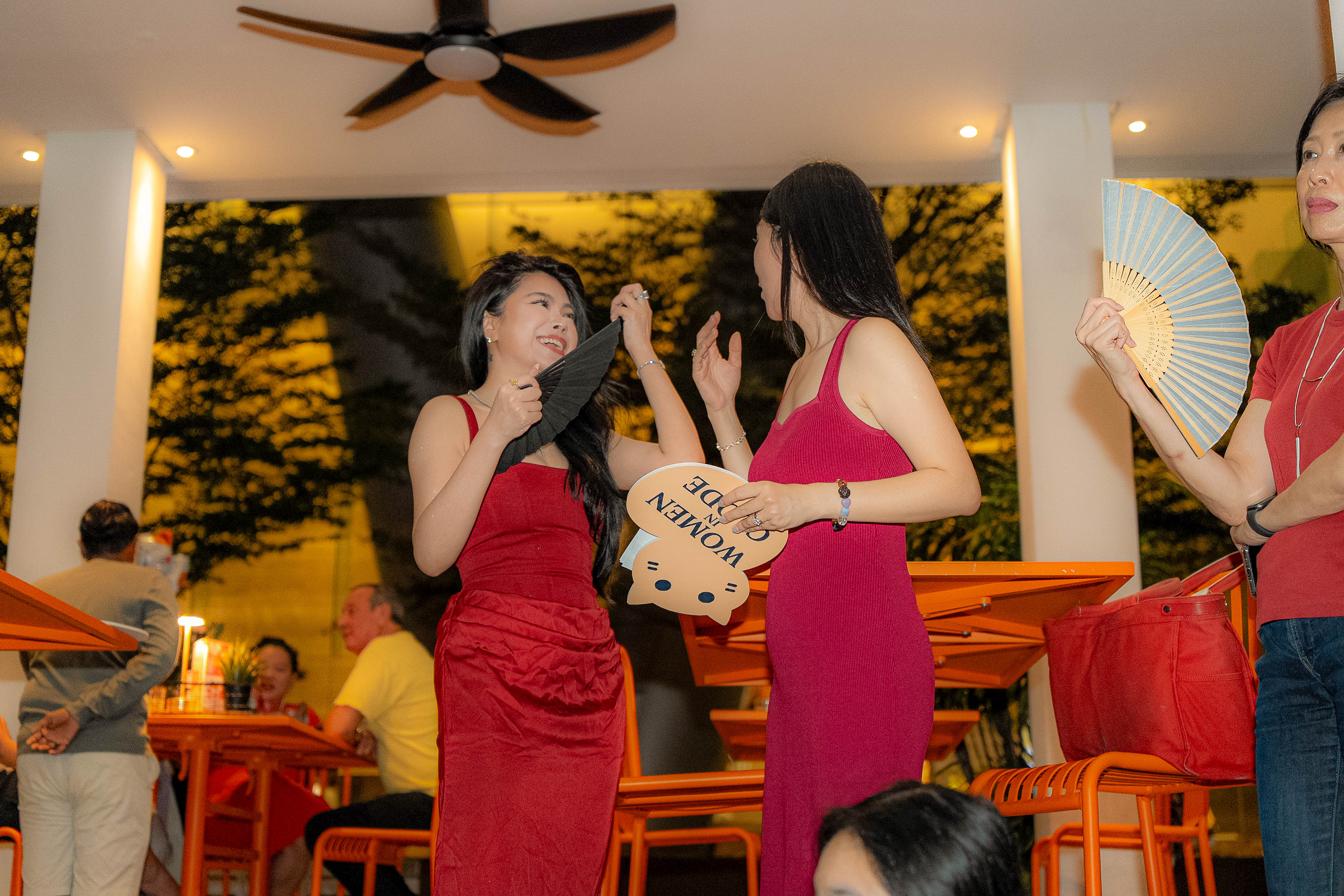 Two Clodettes sharing a laugh with the Women in Clode speech card