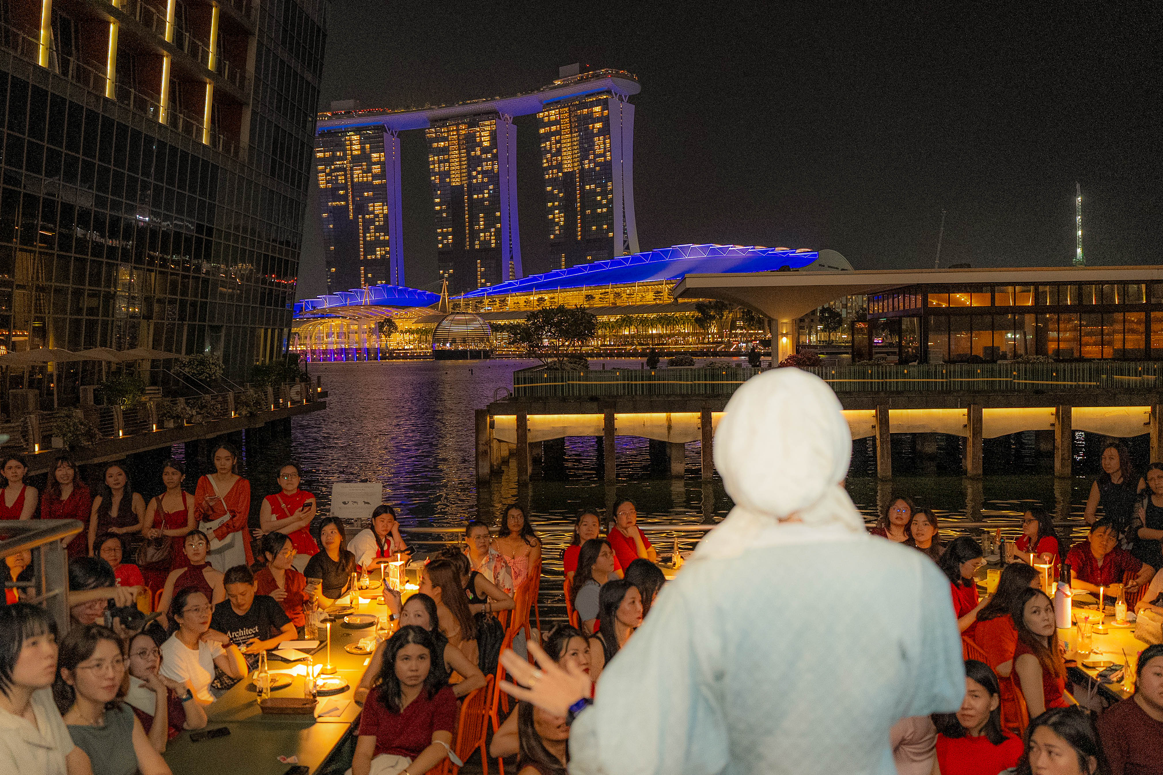 Presenting to the crowd with Marina Bay Sands lit up behind